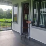 Covered balcony with bar stool, gray tile flooring and mountain views through security windows